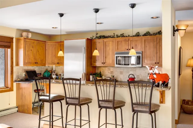 a view of a dining room with furniture and floor to ceiling window