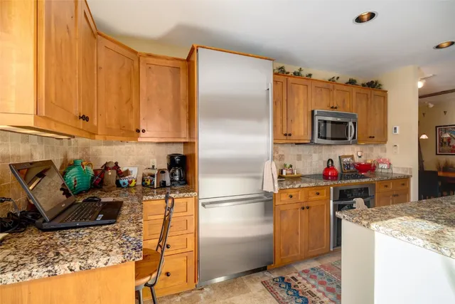 a kitchen with a refrigerator stove and sink