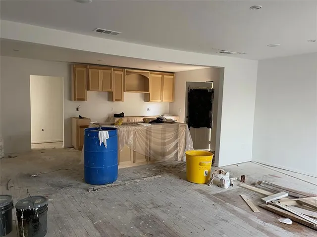a view of a small space with wooden floor and a window