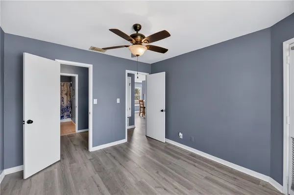 a view of an empty room with wooden floor