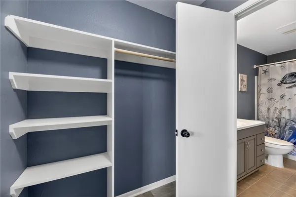 a room with a closet and a toilet