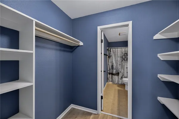 a bathroom with a toilet a sink and a mirror