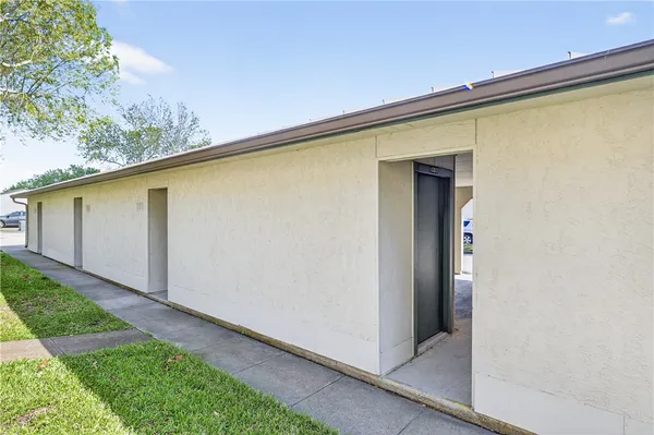 a front view of a house with parking space and a garage