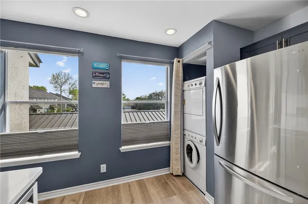 a view of a refrigerator in kitchen and a window