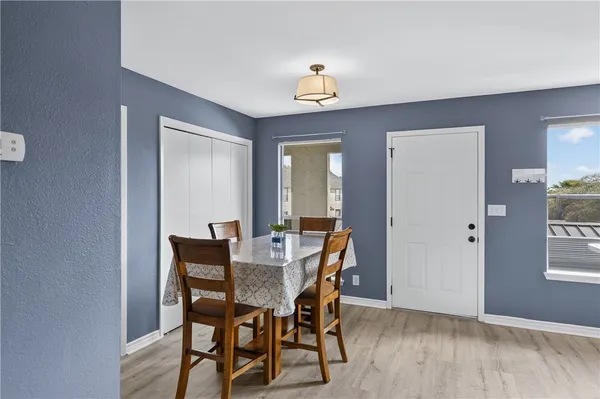 a view of a dining room with furniture and window