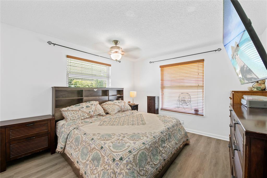 220 South Golf Boulevard Pompano Beach, FL 33064 - Photo 12 of 35 a bedroom with a bed a dresser next to a window