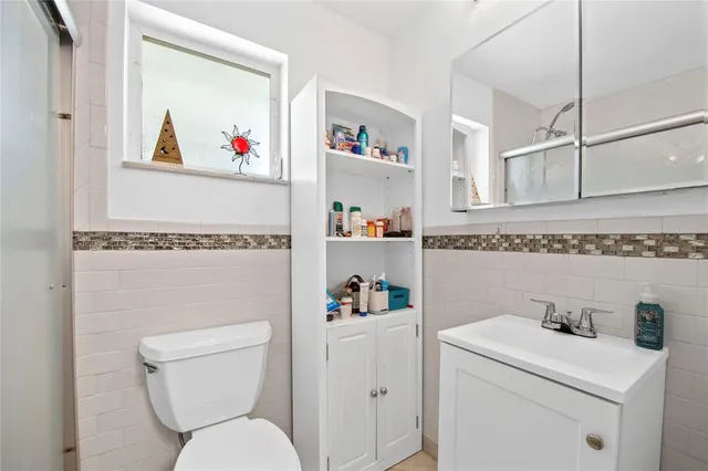 a white toilet sitting next to a bathroom sink
