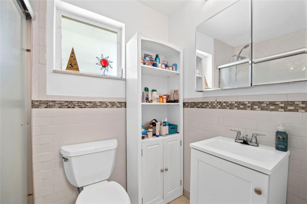 220 South Golf Boulevard Pompano Beach, FL 33064 - Photo 14 of 35 a white toilet sitting next to a bathroom sink