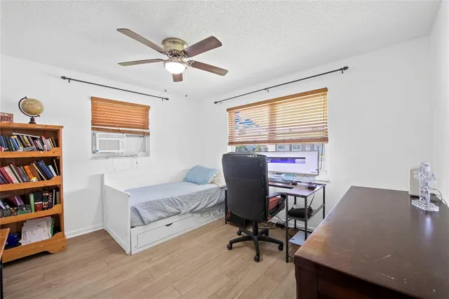 a workspace with furniture bookshelf and a window