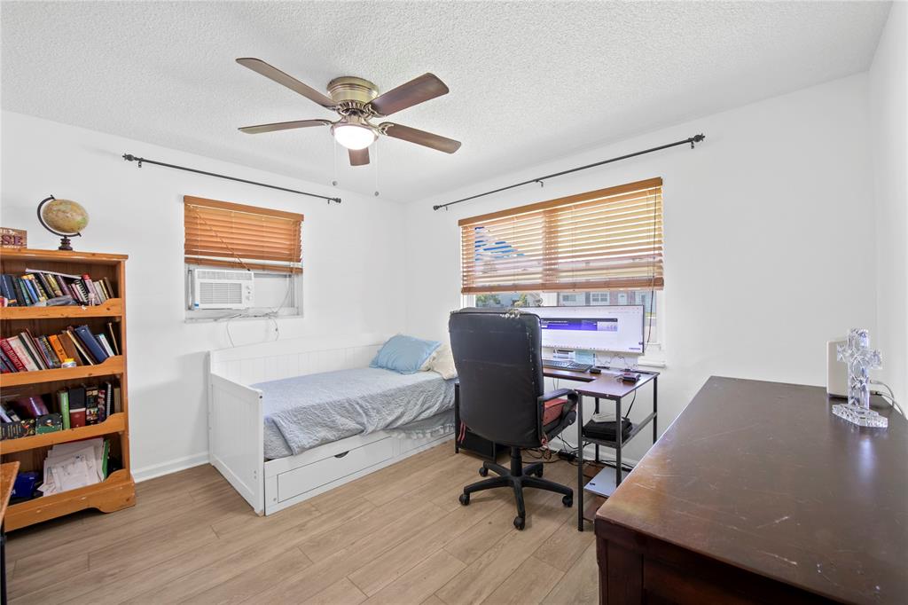 220 South Golf Boulevard Pompano Beach, FL 33064 - Photo 18 of 35 a workspace with furniture bookshelf and a window