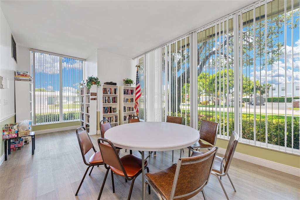 220 South Golf Boulevard Pompano Beach, FL 33064 - Photo 27 of 35 a view of a dining room with furniture and wooden floor