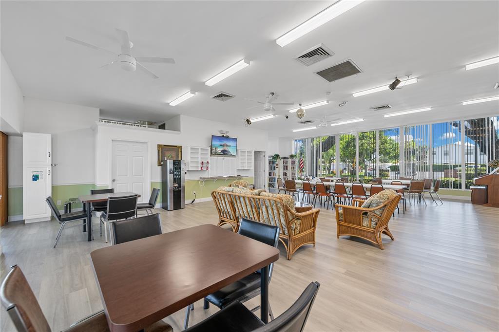 220 South Golf Boulevard Pompano Beach, FL 33064 - Photo 29 of 35 a view of a dining room with furniture window and wooden floor