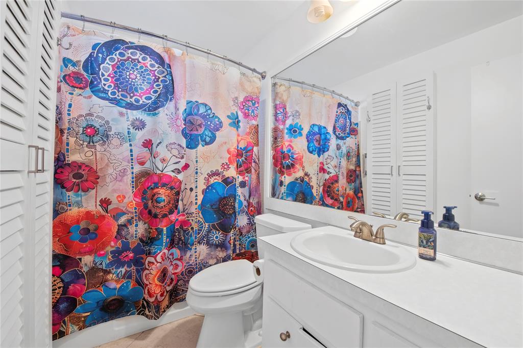 220 South Golf Boulevard Pompano Beach, FL 33064 - Photo 9 of 35 a bathroom with a sink a toilet and curtain