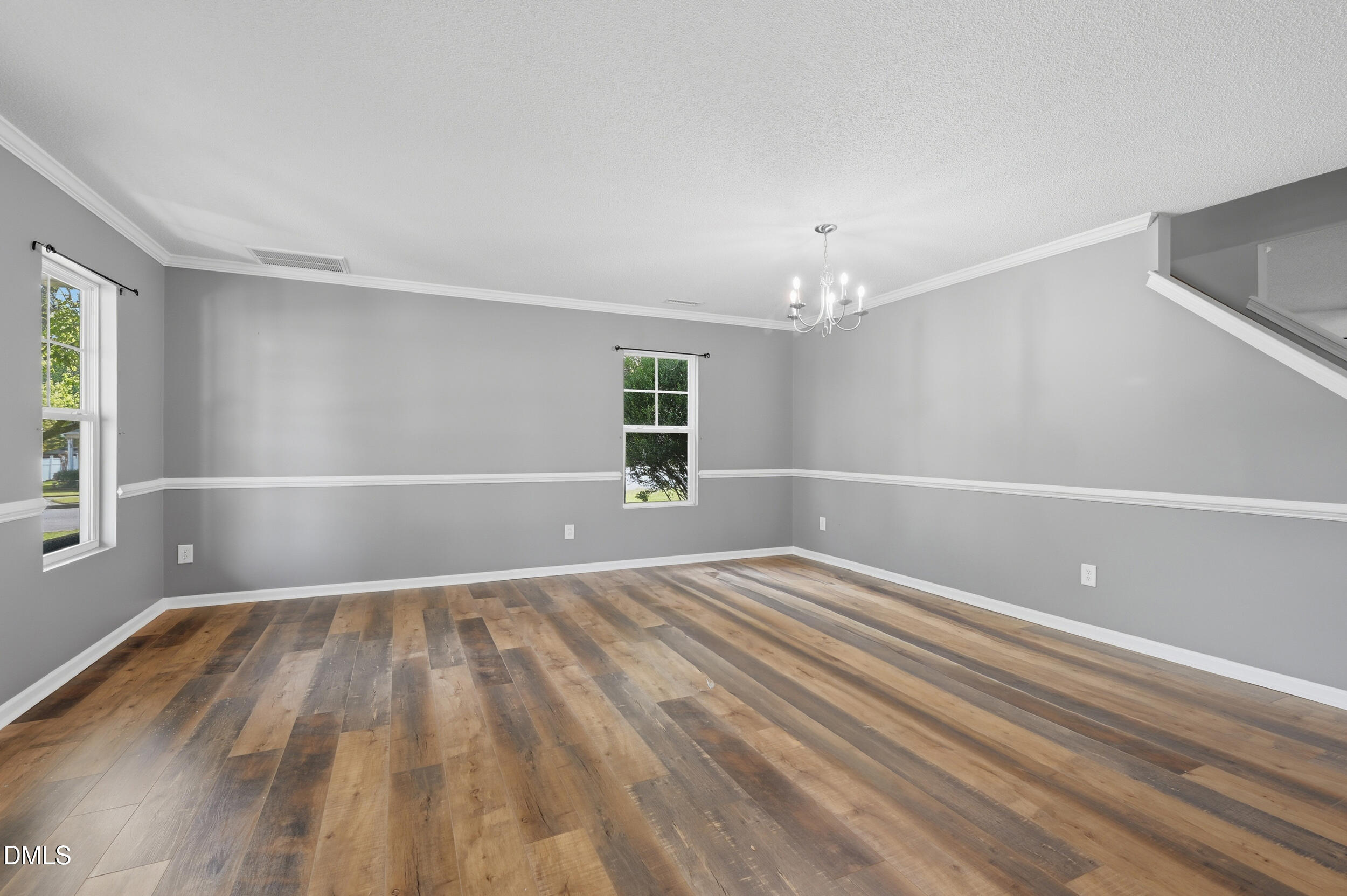 148 Brockton Ridge Drive Garner, NC 27529 - Photo 6 of 39 a view of an empty room with wooden floor and a window