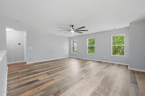 a kitchen with stainless steel appliances granite countertop a stove a sink dishwasher a refrigerator and a oven with wooden floor