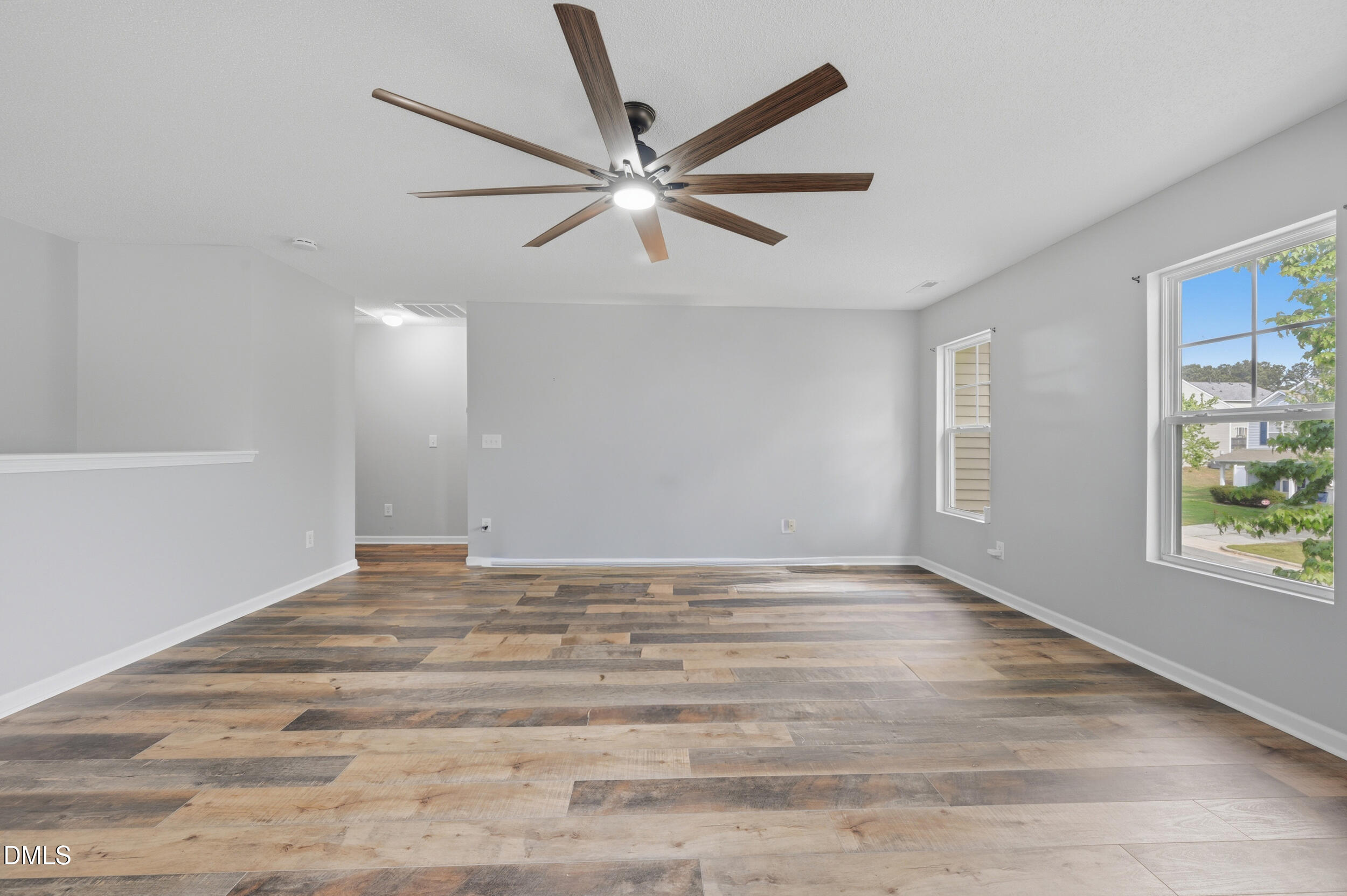 148 Brockton Ridge Drive Garner, NC 27529 - Photo 17 of 39 a view of an empty room with window and wooden floor