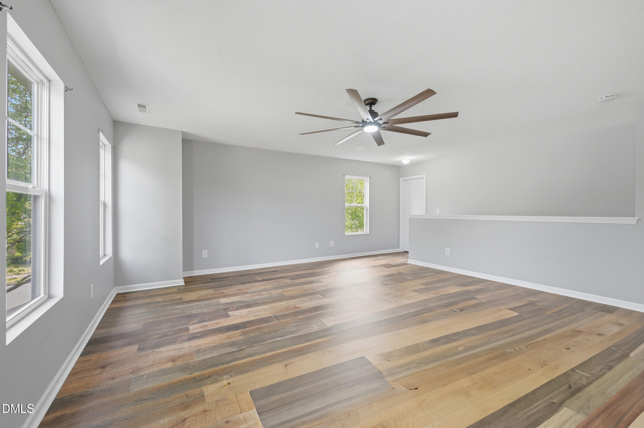148 Brockton Ridge Drive Garner, NC 27529 - Photo 18 of 39 a view of an empty room with window and wooden floor
