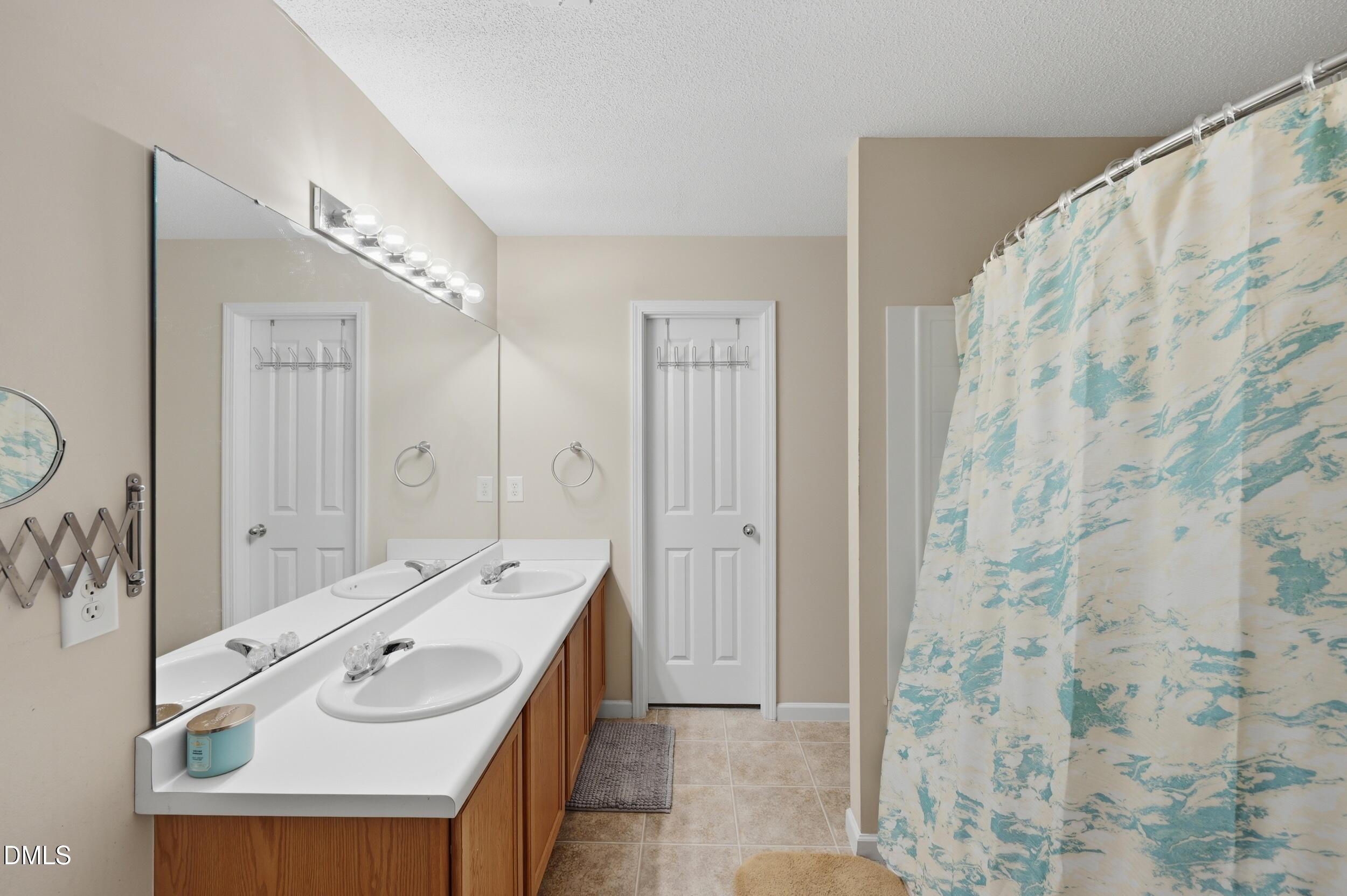 148 Brockton Ridge Drive Garner, NC 27529 - Photo 22 of 39 a spacious bathroom with a sink a mirror and a shower