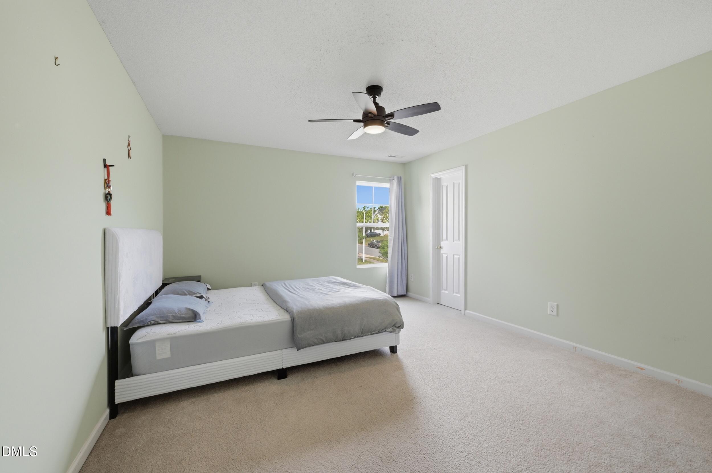 148 Brockton Ridge Drive Garner, NC 27529 - Photo 23 of 39 a bedroom with a bed and a ceiling fan