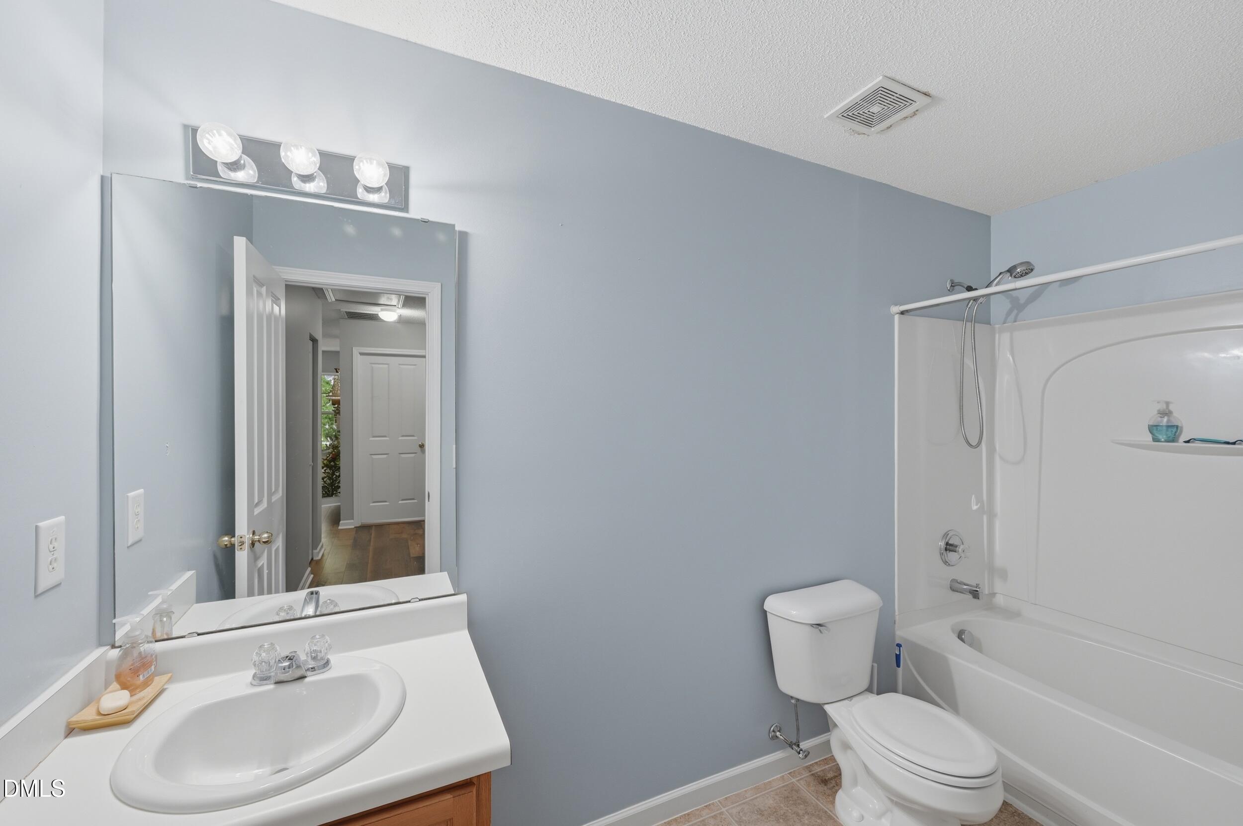 148 Brockton Ridge Drive Garner, NC 27529 - Photo 24 of 39 a bathroom with a sink a toilet and shower