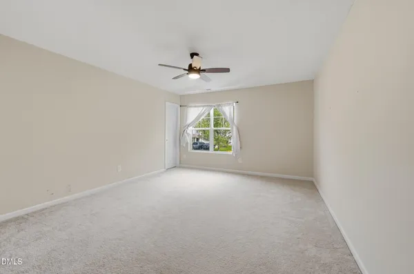 a view of a room with a ceiling fan