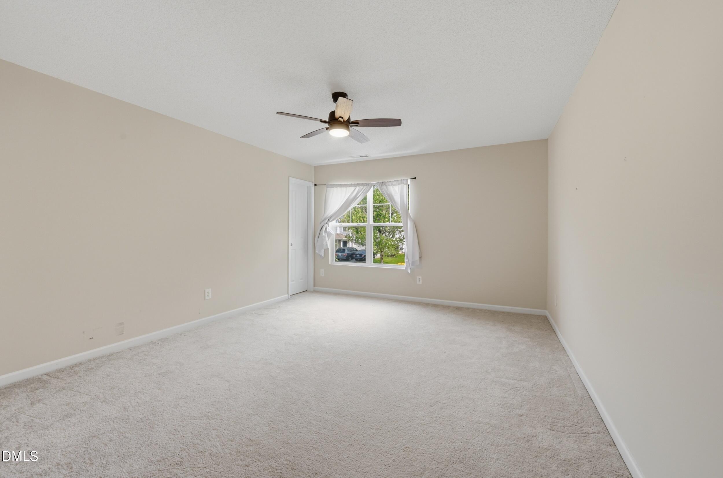 148 Brockton Ridge Drive Garner, NC 27529 - Photo 25 of 39 an empty room with windows and ceiling fan