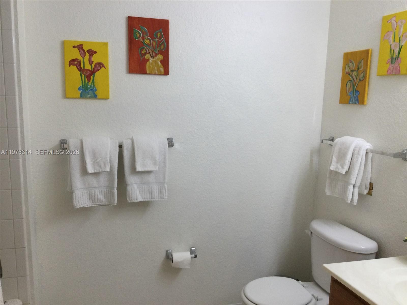 4601 Yellowgold Road West, Unit B8104 Kissimmee, FL 34746 - Photo 12 of 16 a white toilet sitting next to a bathroom sink