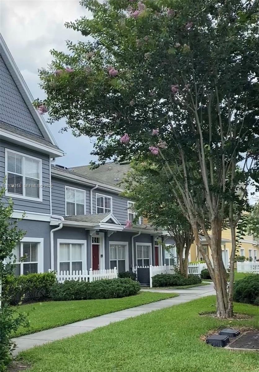 4601 Yellowgold Road West, Unit B8104 Kissimmee, FL 34746 - Photo 2 of 16 a front view of a house with a garden