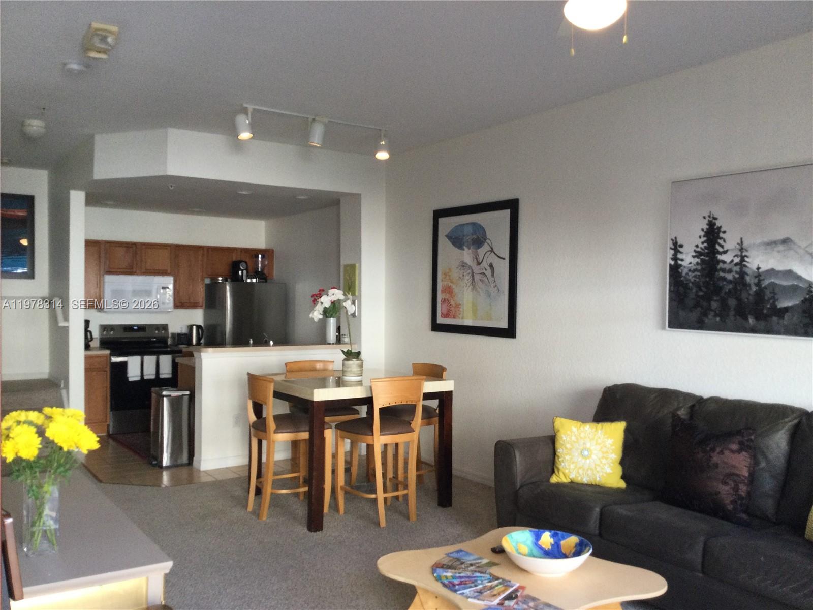 4601 Yellowgold Road West, Unit B8104 Kissimmee, FL 34746 - Photo 3 of 16 a living room with furniture and kitchen view