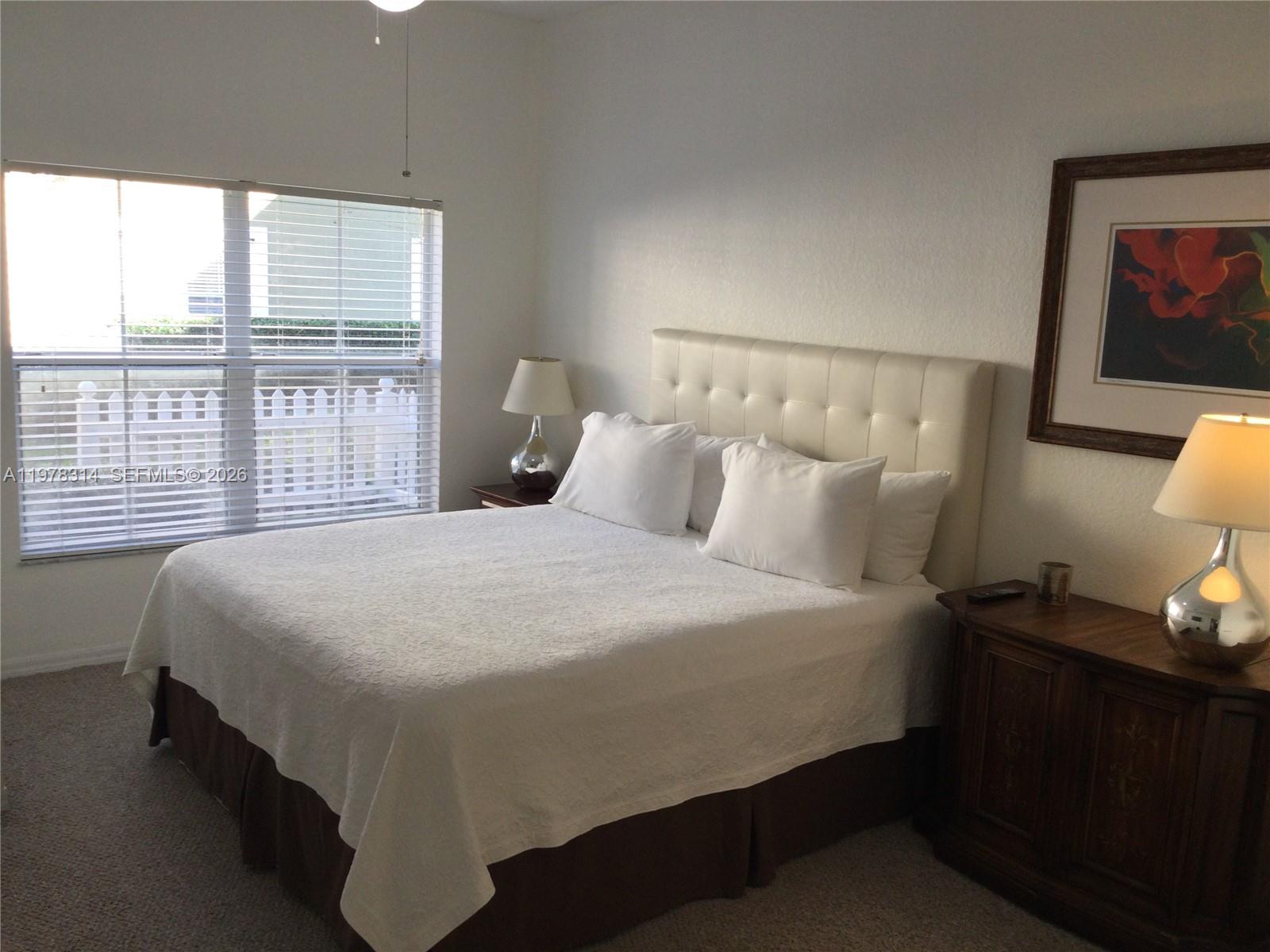 4601 Yellowgold Road West, Unit B8104 Kissimmee, FL 34746 - Photo 6 of 16 a bedroom with a bed and a large window