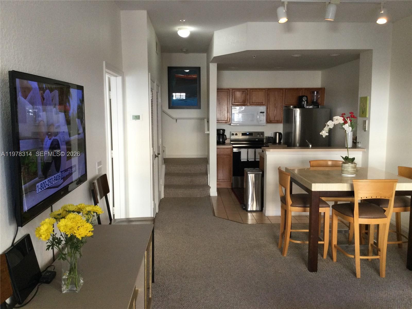 4601 Yellowgold Road West, Unit B8104 Kissimmee, FL 34746 - Photo 8 of 16 a kitchen with stainless steel appliances kitchen island granite countertop a refrigerator and a sink