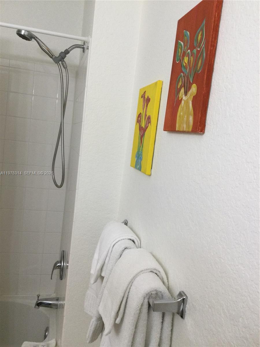 4601 Yellowgold Road West, Unit B8104 Kissimmee, FL 34746 - Photo 9 of 16 a bathroom with a shower and a bathtub