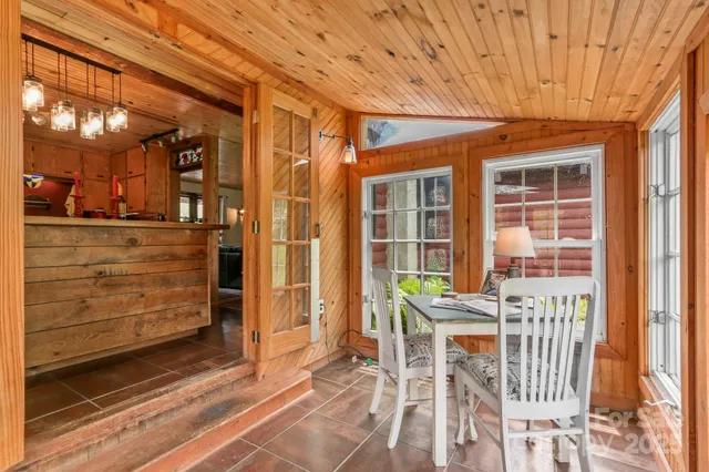 a view of a dining room with furniture and chandelier