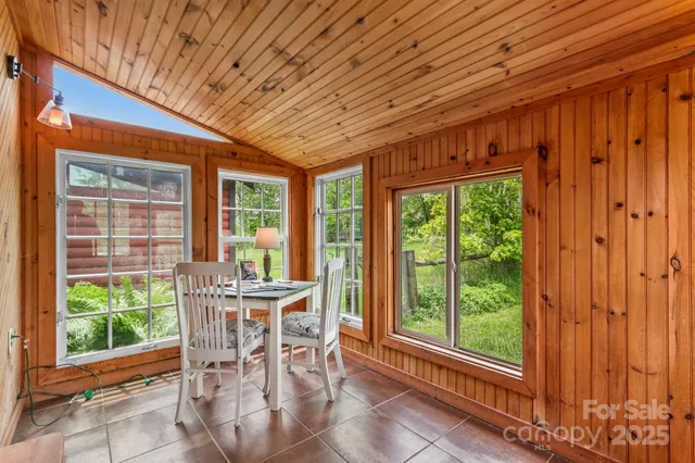 a dining room with furniture window and outside view