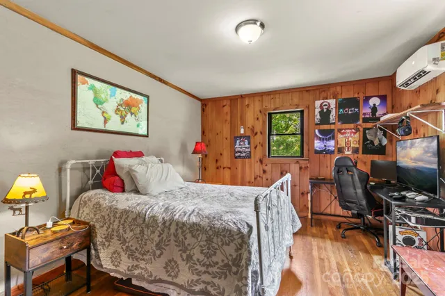 a bed room with a bed and a tv