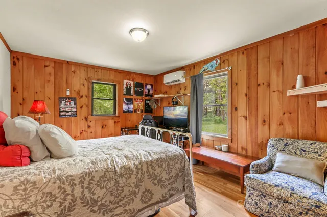 a bedroom with a large bed and a couch next to a window