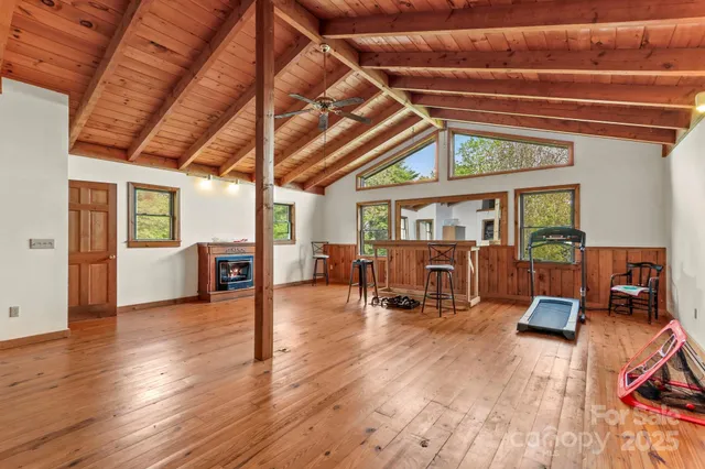 a view of a room with wooden floor and furniture