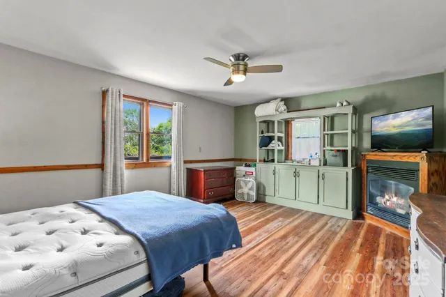 a bedroom with a bed and a television