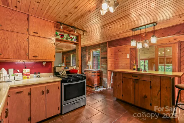 a kitchen with stainless steel appliances a stove and cabinets