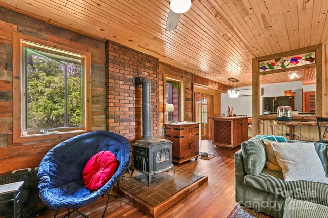 a living room with furniture a rug and a large window