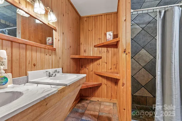 a spacious bathroom with a granite countertop sink and a mirror