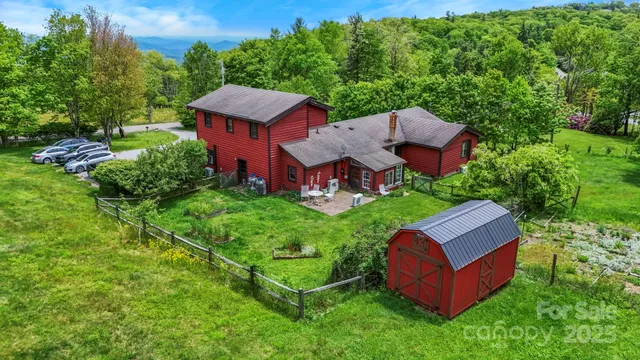 an aerial view of a house with garden space and a house