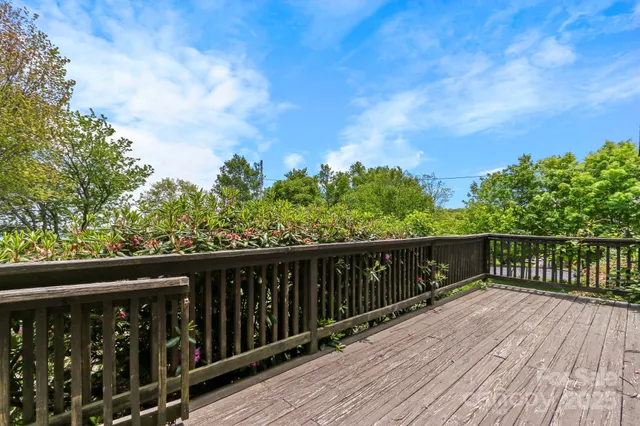 a balcony with wooden floor and fence