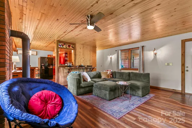 a living room with furniture a chandelier and a rug