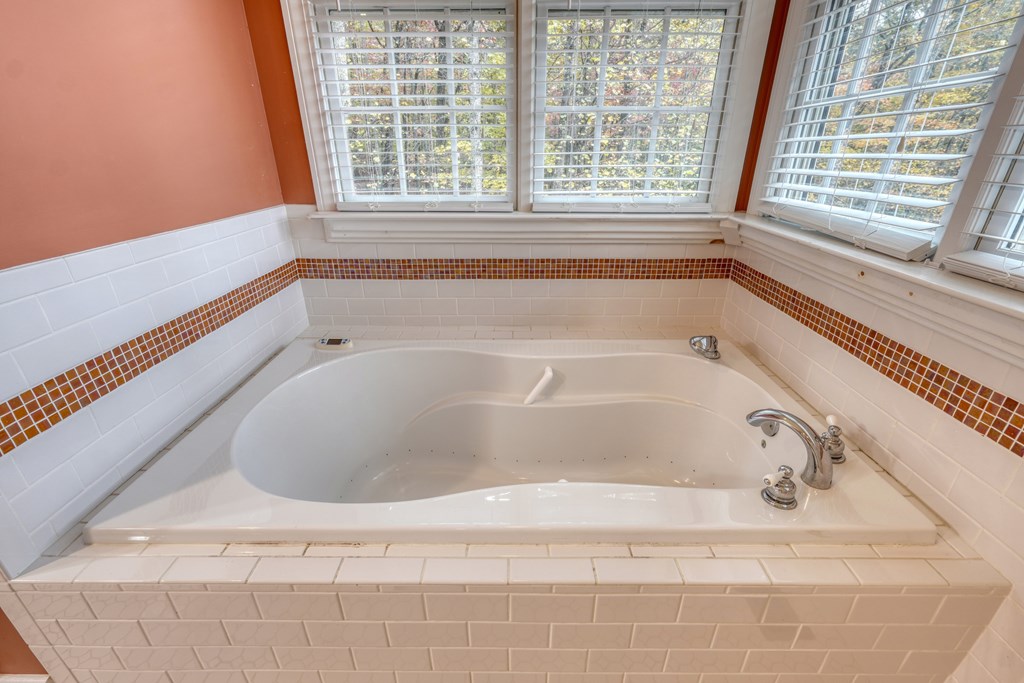 1837 Deep South Farm Road Blairsville, GA 30512 - Photo 38 of 76 a bath tub sitting in a bathroom next to a window