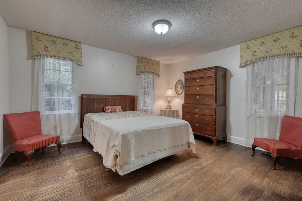 1837 Deep South Farm Road Blairsville, GA 30512 - Photo 42 of 76 a bedroom with a bed and wooden floor