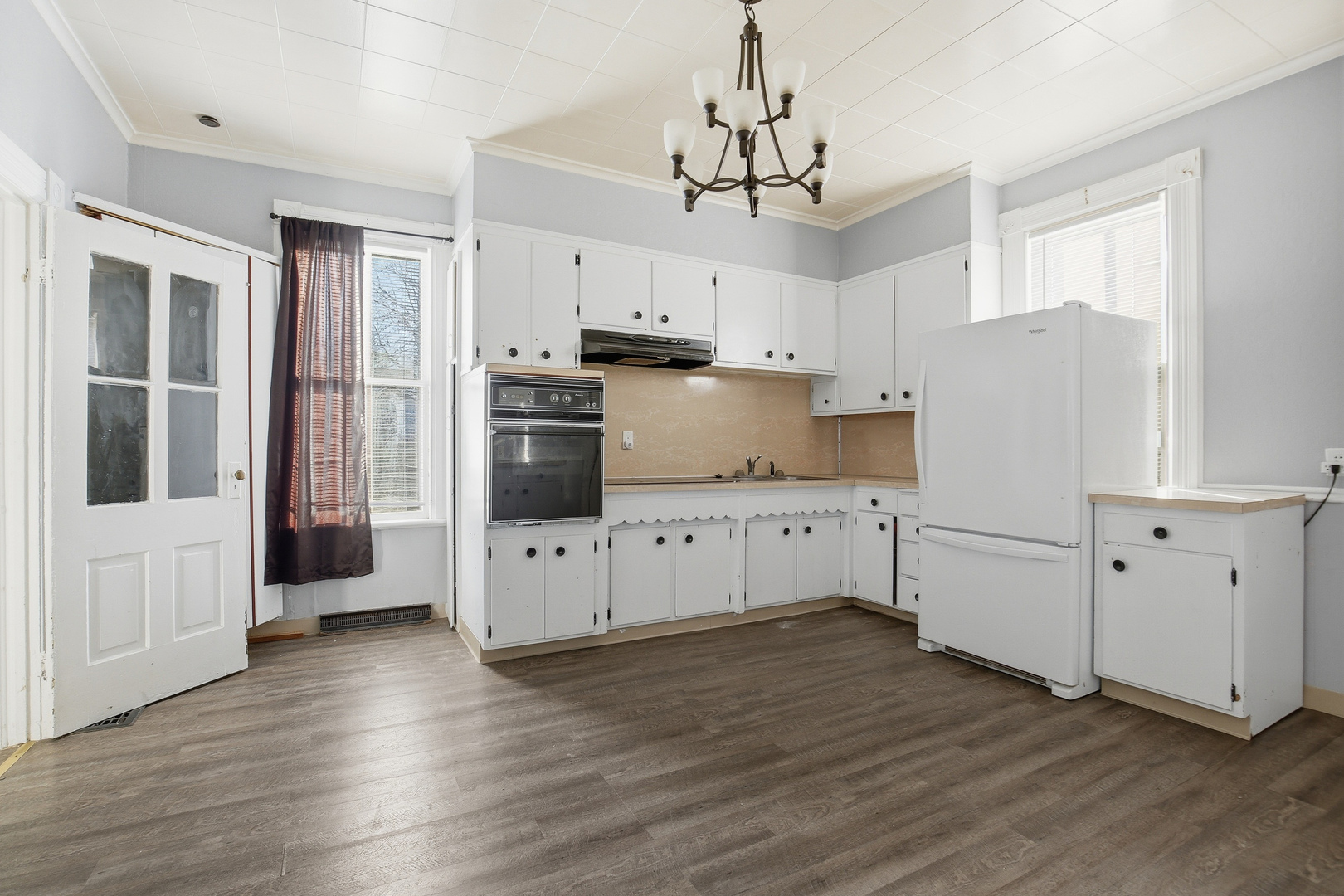 2115 West 4th Street Davenport, IA 52802 - Photo 18 of 24 a kitchen with cabinets and wooden floor