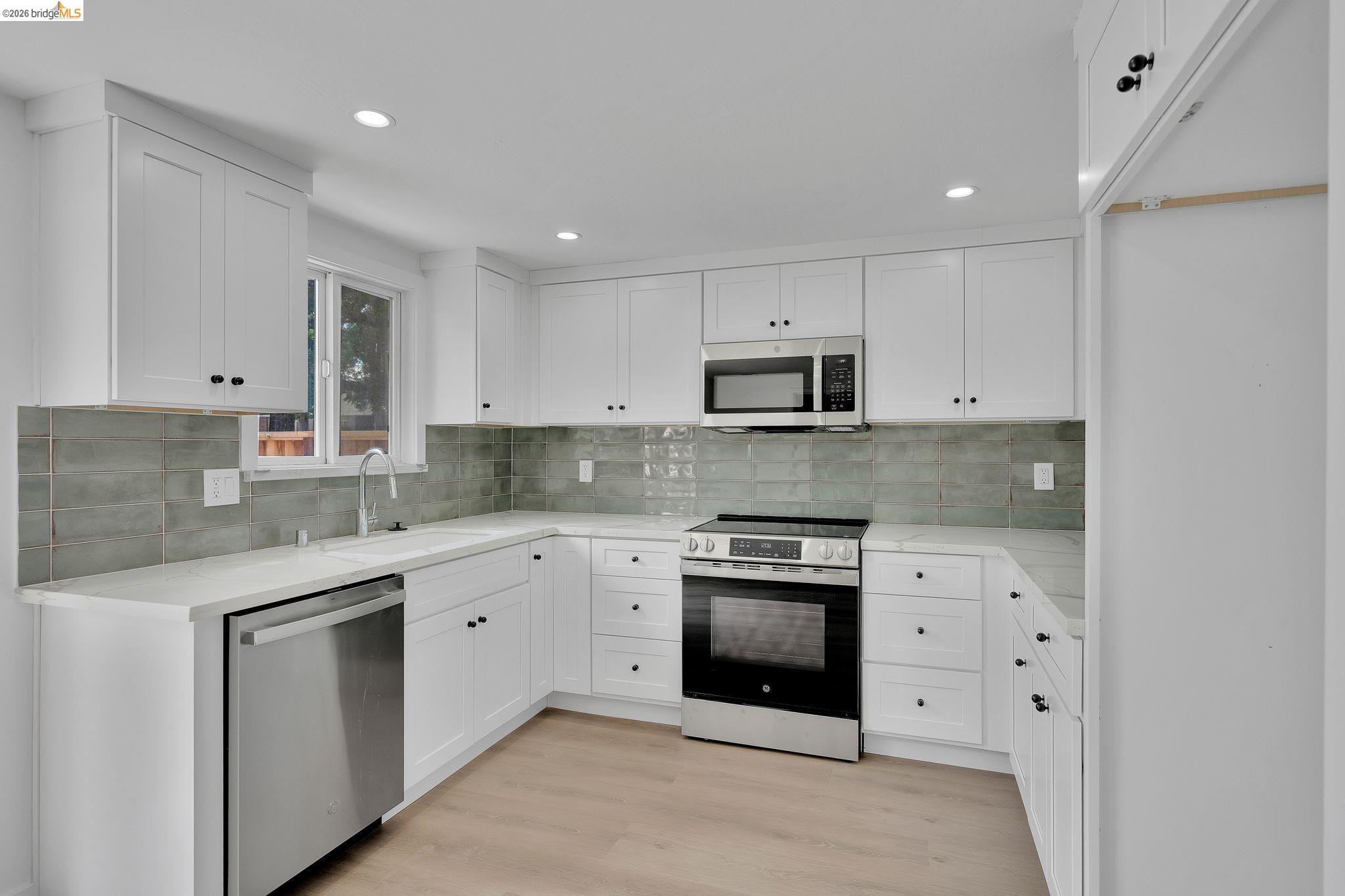 1808 Wildbrook Court, Unit D Concord, CA 94521 - Photo 15 of 47 a kitchen with white cabinets stainless steel appliances and sink