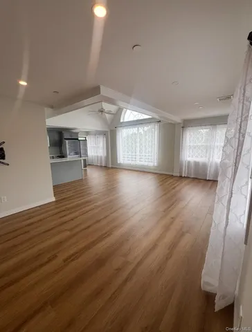 a view of an empty room and wooden floor