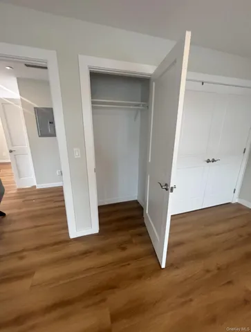 a view of room with window and wooden floor